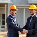 Satisfied client shaking hands with Albion Construction lead, smiling