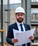 Peter Jones, Lead Structural Engineer, holding engineering plans