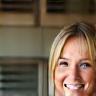 Sarah L., homeowner, smiling at renovated kitchen
