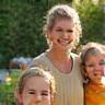 Sofia G., family homeowner, with her children in garden